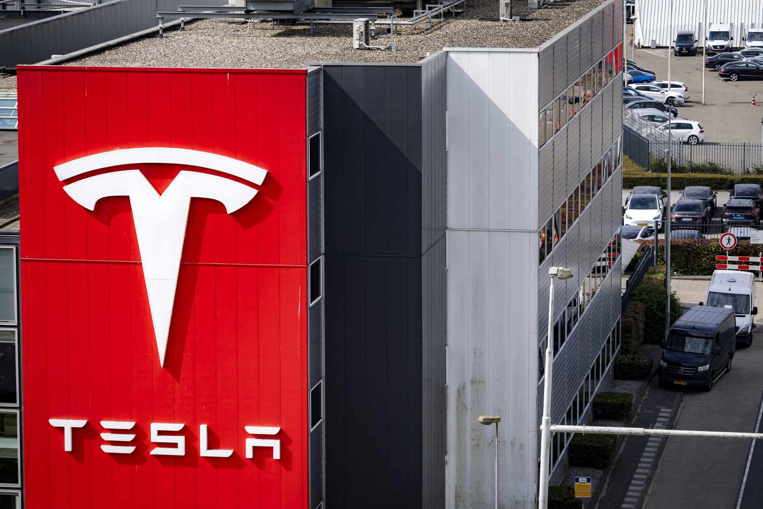 Tesla Stock Drops as Earnings Rally Slows 3 June 14, 2025 10:50 am Tesla Stock Drops as Earnings Rally Slows The Tesla logo on the side of a building, with cars in the background