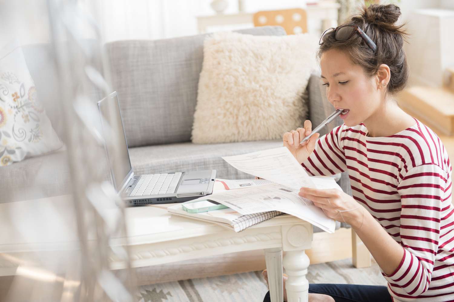 Finest Private Loans With No Origination Charges for 2025 46 July 27, 2025 5:25 pm Finest Private Loans With No Origination Charges for 2025 A young woman with her hair tied up and sunglasses perched on her head sits on the floor near a low table in a living room. She is wearing a red and white striped shirt and holding a pen to her mouth while concentrating on papers in her hands. A laptop, notebook, and other documents are spread out on the table in front of her, suggesting she is working or studying. The cozy room features a gray couch with decorative pillows and a fluffy beige cushion in the background.