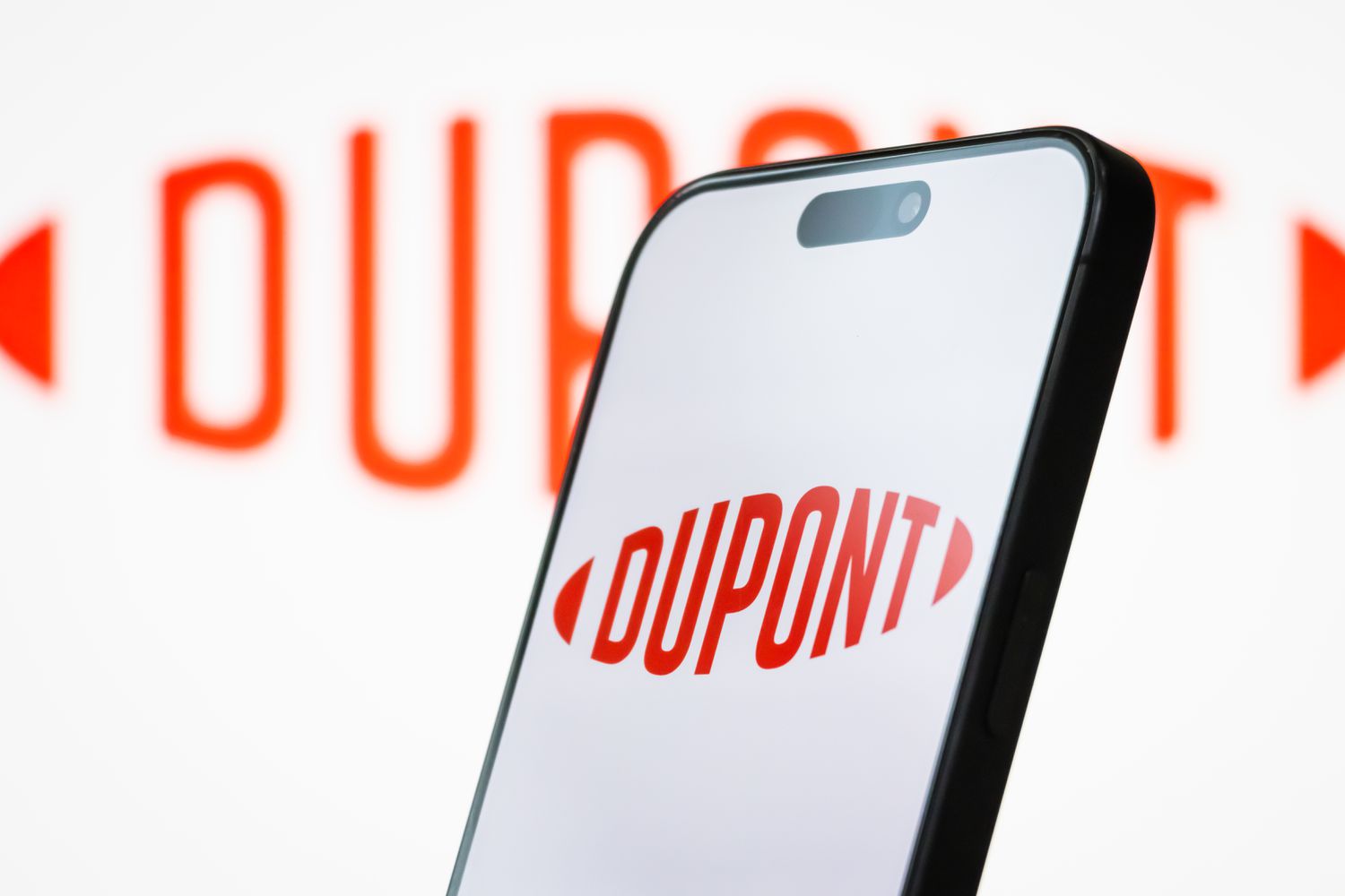 DuPont Tops Profit, Sales Estimates, Gives Estimate of Tariff Impact 4 June 14, 2025 11:08 am DuPont Tops Profit, Sales Estimates, Gives Estimate of Tariff Impact The logo of DuPont de Nemours, Inc. is displayed on a smartphone screen, with the company's red branding visible in the background
