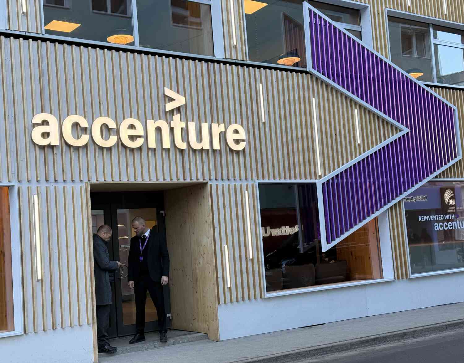 Accenture Inventory Sinks as Revenue Falls Brief, CEO Says Authorities Gross sales Slowing 3 June 16, 2025 4:47 pm Accenture Inventory Sinks as Revenue Falls Brief, CEO Says Authorities Gross sales Slowing The Accenture logo is seen above the entrance to an office building, with a large purple logo to the right.