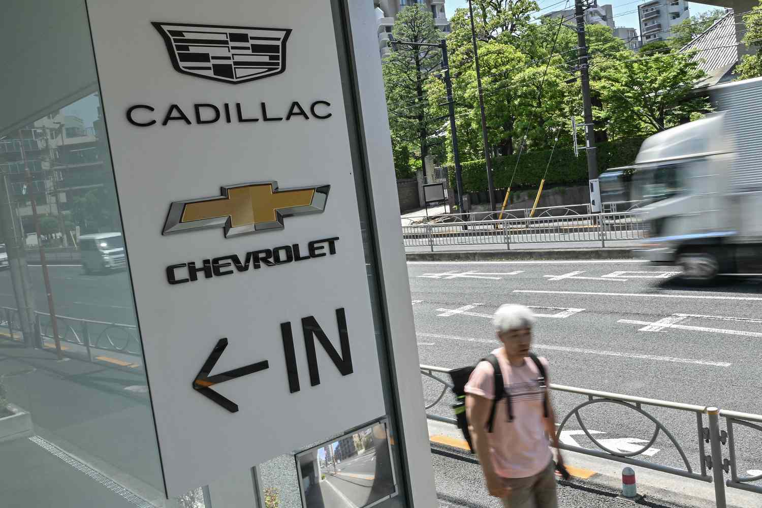 GM warns that tariffs will cut full-year profits by $4B - $5B 4 June 14, 2025 11:34 am GM warns that tariffs will cut full-year profits by $4B - $5B A pedestrian walks past a car dealership which sells US auto brands Cadillac and Chevrolet, along a street in Tokyo