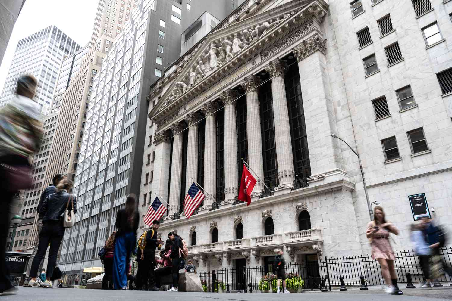 People walk near the New York Stock Exchange.