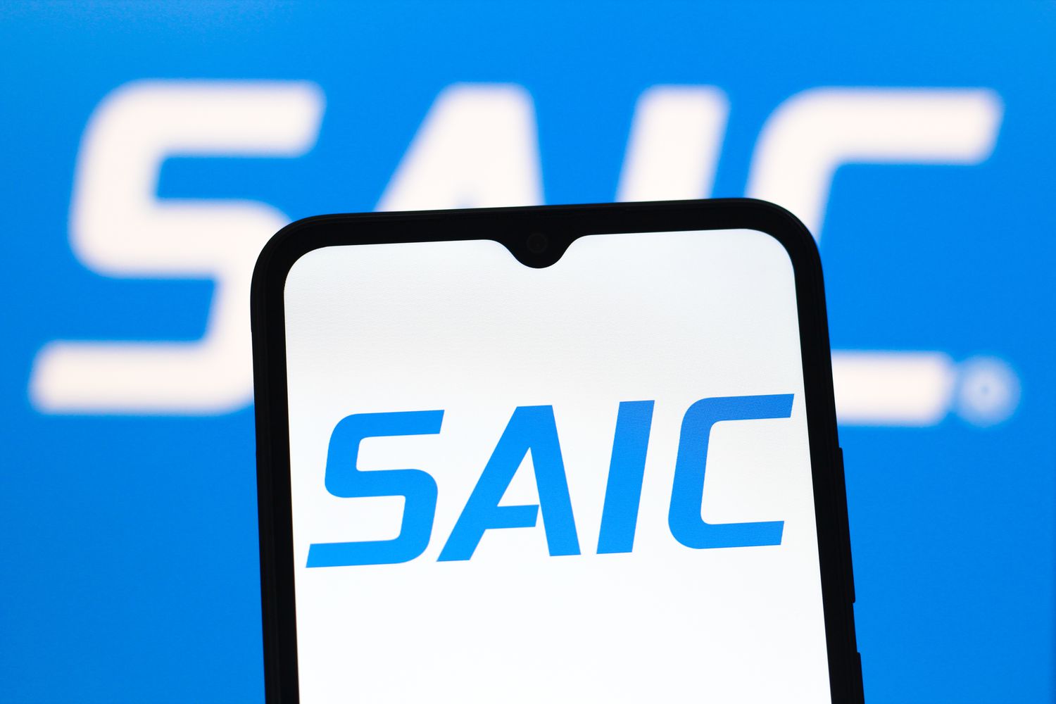 SAIC stock jumps as Govt. Contractor Tops Earnings, Outlook Estimates 3 April 19, 2025 11:52 pm SAIC stock jumps as Govt. Contractor Tops Earnings, Outlook Estimates The blue SAIC logo is seen on a phone screen, with the same logo in the background.